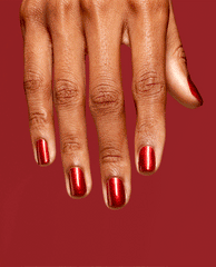 Hand with short, neatly manicured nails showcases CD Rom-antic OPI nail polish, a high-shine metallic red nail lacquer, against a matching deep red background for a bold, glossy finish.