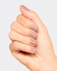 Hand displaying a glossy mauve-taupe manicure with OPI France-y Seeing You Here gel nail polish, a soft neutral shade for fall nail colors, on a clean light gray background.