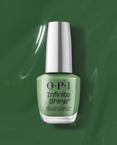 OPI Infinite Shine Happily Evergreen After green nail polish bottle with silver cap and Gel-Like Lacquer label, standing centered on a glossy deep-green background; a creamy sage hue ideal for spring nail colors from OPI.