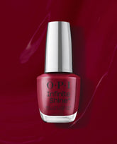 OPI Infinite Shine Malaga Wine gel-like nail lacquer bottle in a rich wine-red shade, shown against a glossy burgundy polish background for fall nail colors.