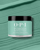 OPI Rated Pea-G Powder Perfection dipping powder jar centered on a textured mint/pea-green backdrop, showcasing a fresh green nail polish shade ideal for spring nail colors, perfect for long-lasting OPI dip manicures.