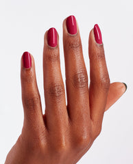 Hand with medium-length nails painted in Red-Veal Your Truth, a deep berry-red OPI nail polish nail lacquer, held against a clean white background to showcase the glossy, full-coverage manicure color for US shoppers.