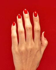 Hand with neatly manicured nails coated in Rust & Relaxation OPI nail polish, showing glossy rust-red nail lacquer against a matching bold red background, highlighting the rich color payoff and smooth salon-quality finish.