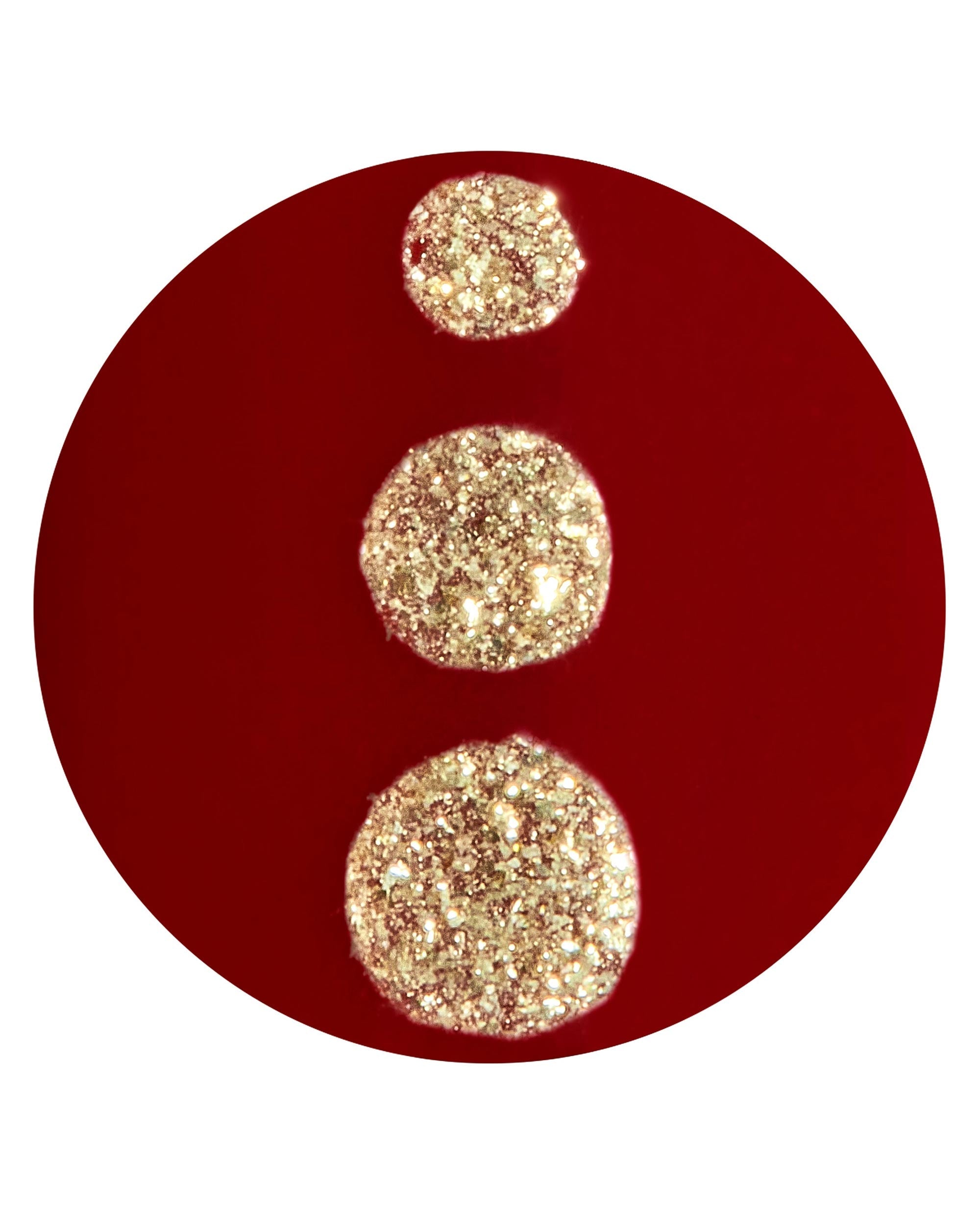 Big Candy Apple Red On Point artificial nail swatch displays glossy deep red polish with three sparkling gold glitter dots on a white background, an OPI fall nail colors look.