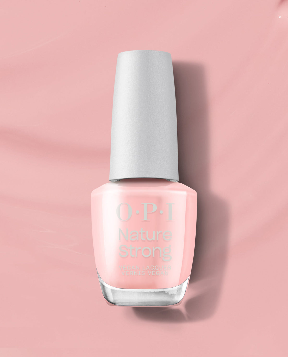 OPI Nature Strong Vegan Nail Lacquer in We Canyon Do Better displayed upright on a soft pink background, showcasing the pale pink natural-origin polish bottle as a premium OPI nail polish gift set option for eco-conscious manicures.