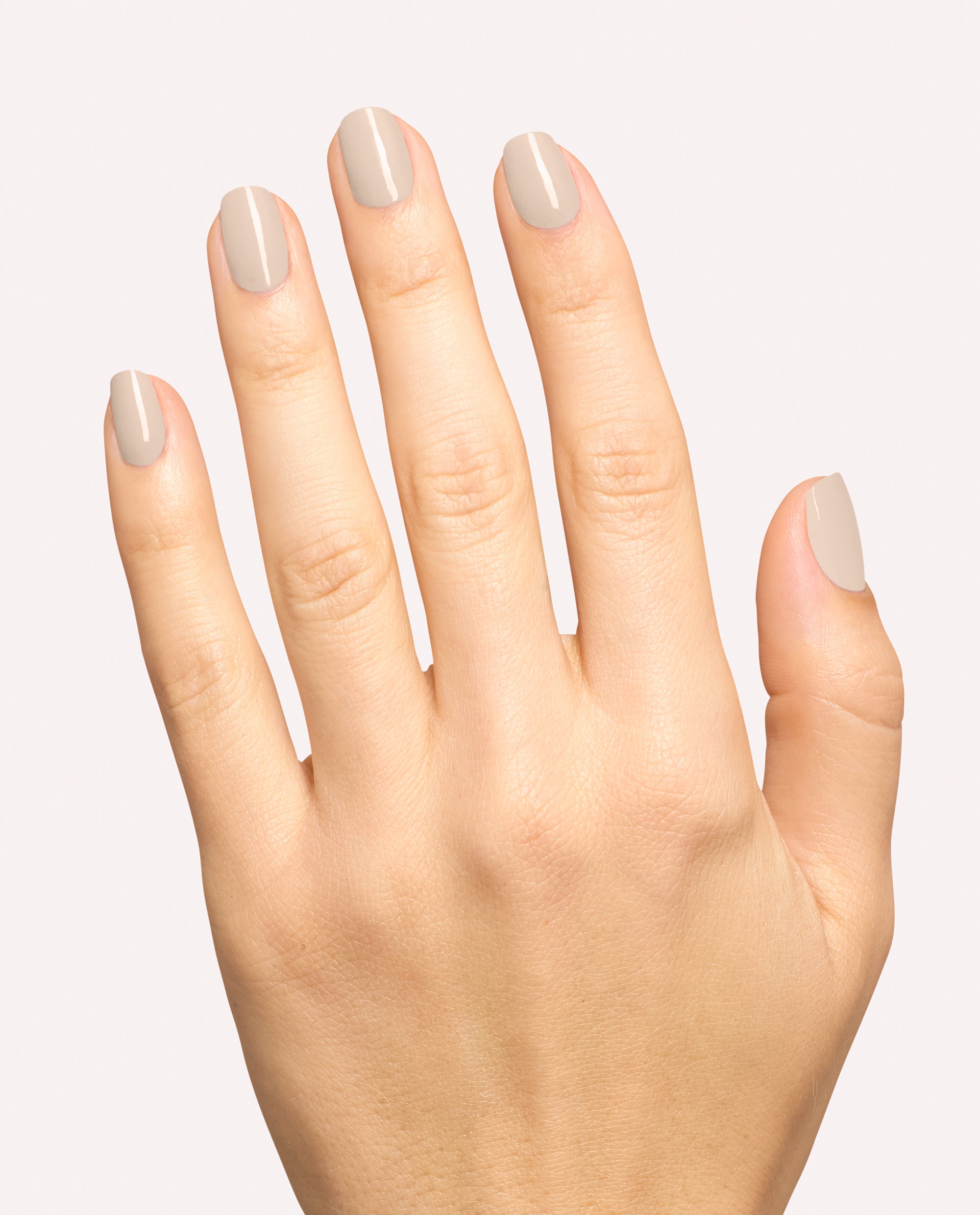 Hand modeling OPI Berlin There, Doin’ That gel nail polish, a glossy taupe-beige shade for neutral fall nail colors on a clean white background.
