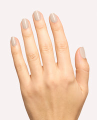 Hand modeling glossy taupe-gray nails using OPI Berlin There, Doin’ That dipping powder, a neutral shade for fall nail colors, against a clean light background.