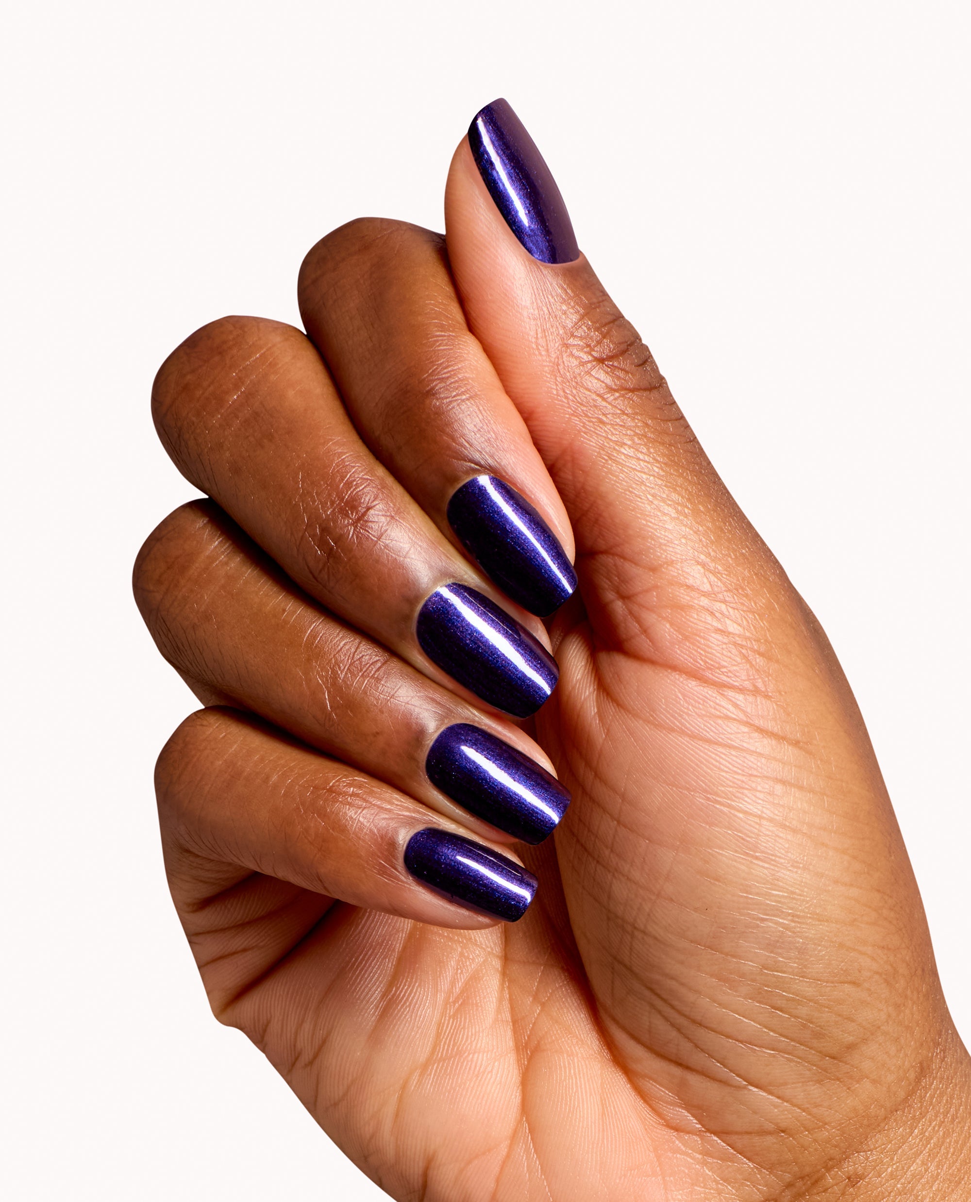 Hand displaying glossy deep purple metallic gel manicure using OPI Don't Over Ink It, a bold shade for fall nail colors, on medium-length rounded square nails.