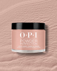 OPI France-y Seeing You Here dipping powder jar sits on a textured blush pink surface, showing a soft rosy nude shade with a glossy black lid for fall nail colors.