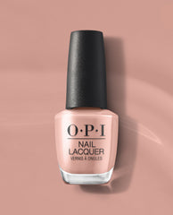 OPI France-y Seeing You Here nail lacquer bottle in a soft rosy nude shade with a black textured cap, displayed on a mauve pink background for fall nail colors.