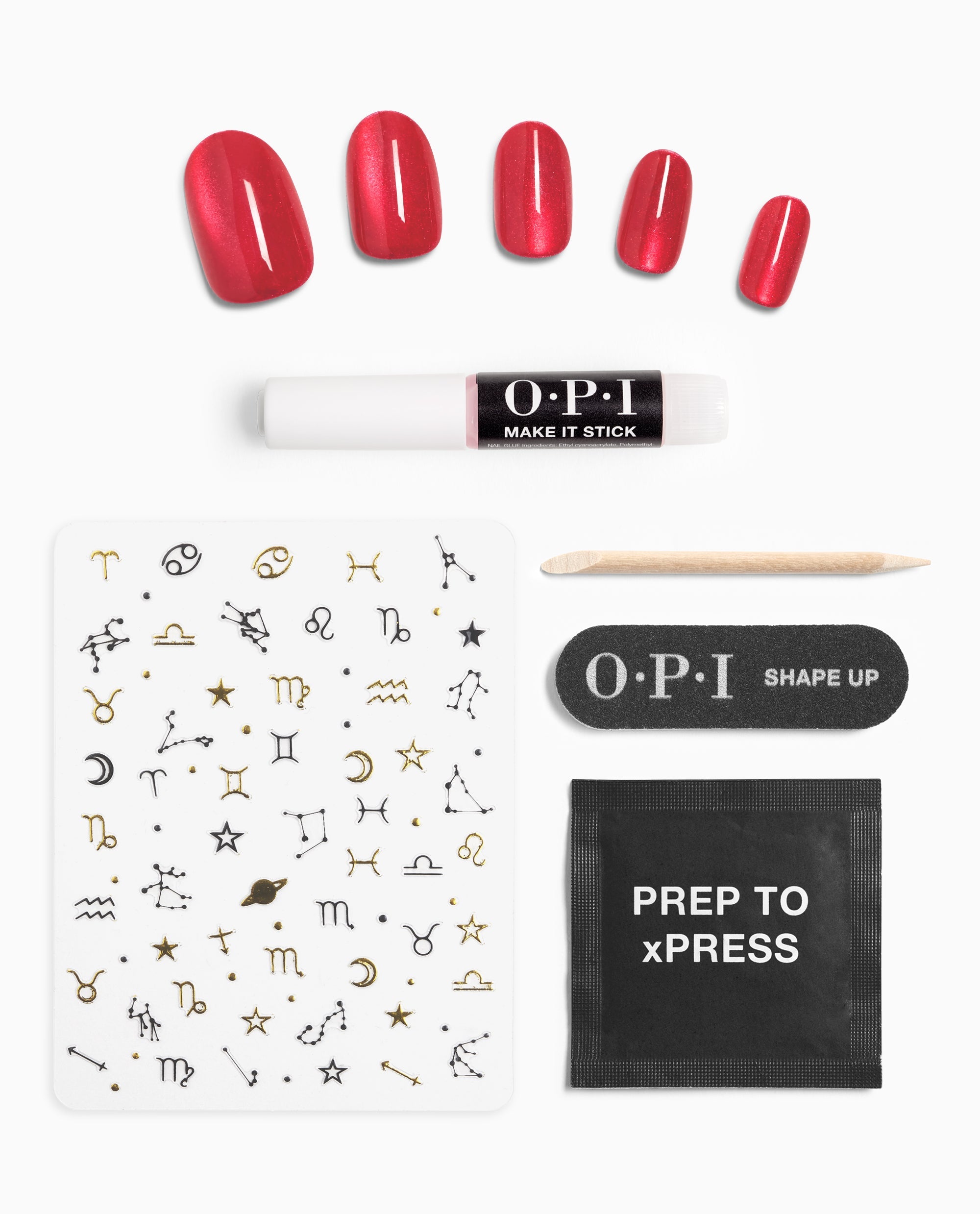 Kiss My Aries xPRESS/ON Effects kit showing glossy red OPI nail polish press-on nails, zodiac nail stickers, Make It Stick adhesive, Shape Up mini file, wooden cuticle stick, and Prep to xPRESS wipe arranged on a white background.