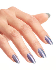 Hand with long oval nails painted in Leonardo’s Model Color, a shimmering lavender-blue OPI nail polish nail lacquer, shown against a bright white background to highlight the metallic, iridescent finish and smooth salon-quality manicure.