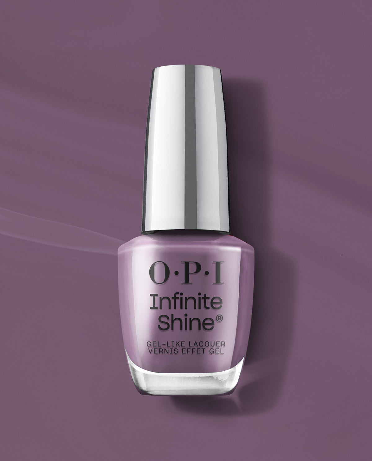 OPI Infinite Shine Reign or Shine gel-like lacquer bottle stands on a mauve purple background, showcasing a soft dusty lavender shade for fall nail colors.