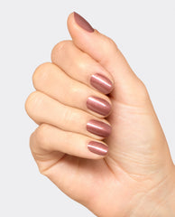 Hand displaying glossy Route Beer Float dipping powder manicure in a warm shimmery mauve-brown shade, styled as an OPI fall nail colors inspiration on a clean white background.