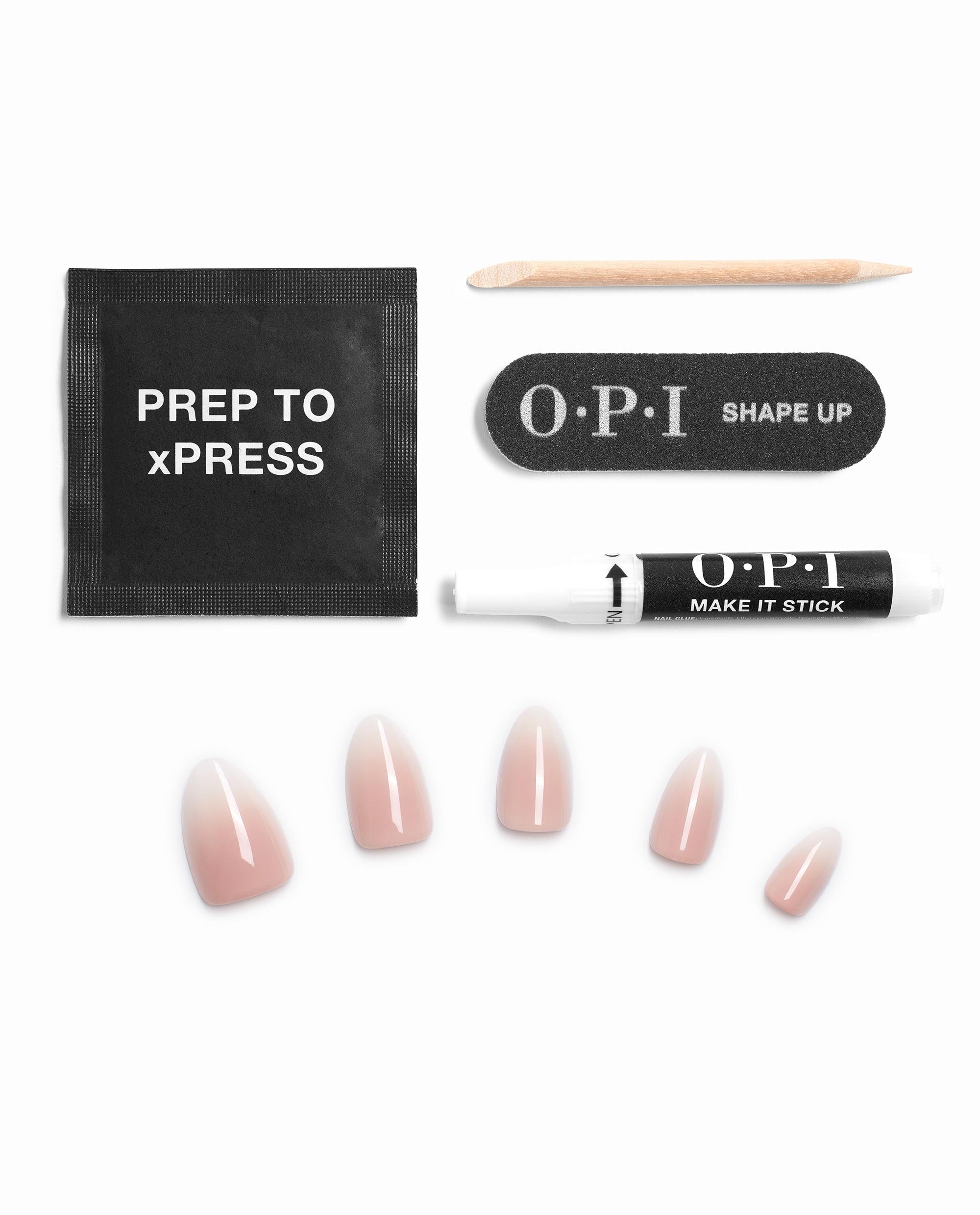 Dream Come Hue xPRESS/ON Nail Art kit from OPI showing soft pink press-on nails, PREP TO xPRESS wipe, wooden cuticle stick, SHAPE UP mini nail file, and MAKE IT STICK adhesive pen arranged neatly on a white background, ideal as an OPI nail polish gift set.