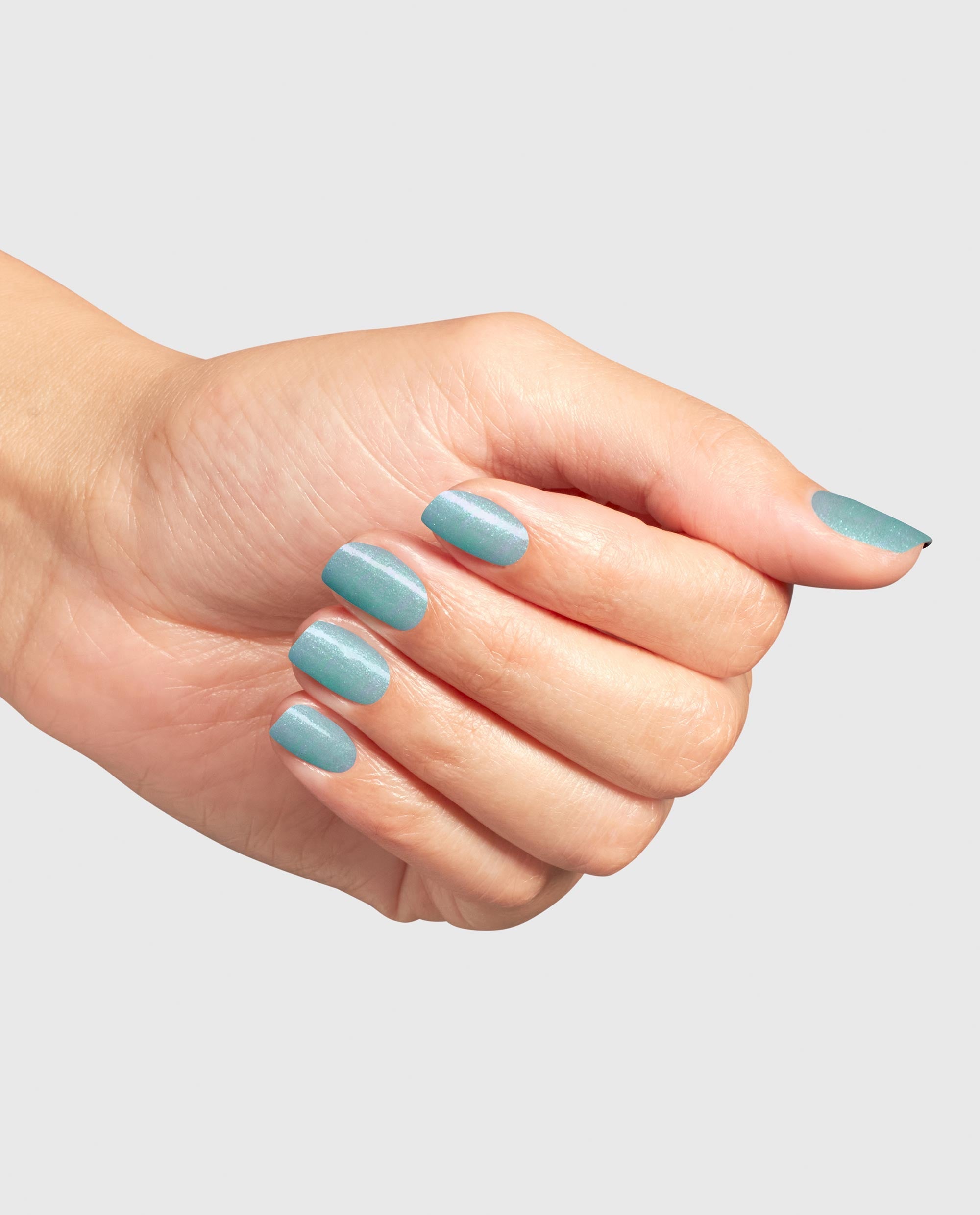Manicured hand showcases Reality Check Ya Out Gel Nail Polish by OPI, a shimmery seafoam green nail polish perfect for spring nail colors, displayed in a close-up against a light gray studio background.