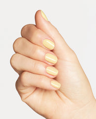 Hand displays glossy pale yellow nails painted with OPI Sunny Bunny Nail Lacquer, shown in a close-up manicure against a clean white background.